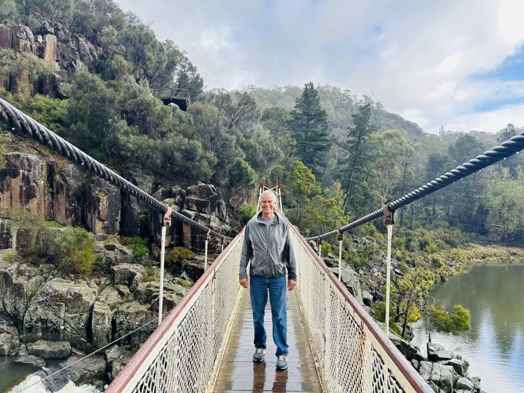 Man stands on Kings Bridge in Cataract Gorge