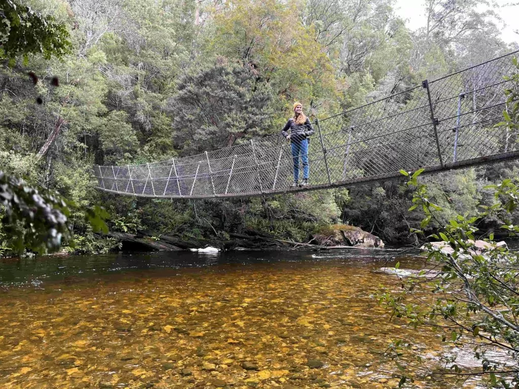 Woman standing on suspension bridge over the Franklin River